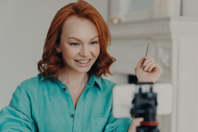 Portrait of young woman using mobile phone