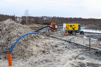 Wellpoint installation to get rid of high groundwater, visible metal pipes and large water pump.