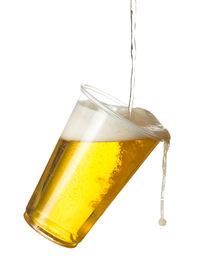 Close-up of beer glass against white background