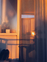 Close-up of illuminated electric lamp on table