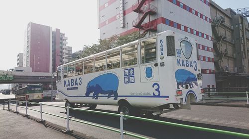 Vehicles on road against buildings in city