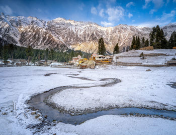 Scenic view of snow covered mountains against sky