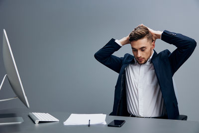 Side view of young businesswoman working at office