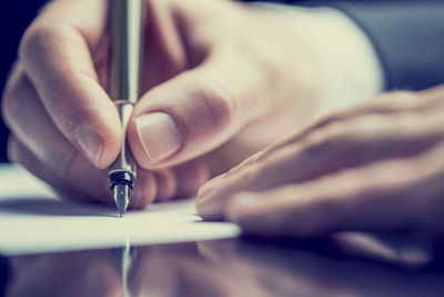 Close-up of human hand holding paper