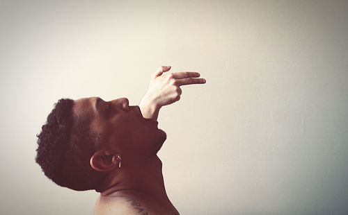 Low angle view of human hand against white background