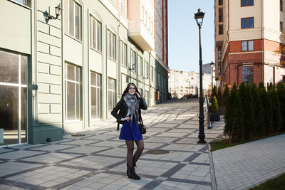 Rear view of woman walking on street in city