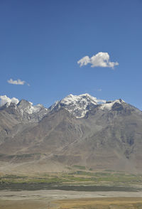 Scenic view of snowcapped mountains against sky