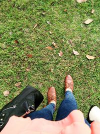 Low section of people sitting on grass