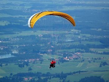 Man paragliding over landscape