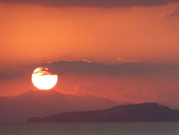 Scenic view of sea against romantic sky at sunset