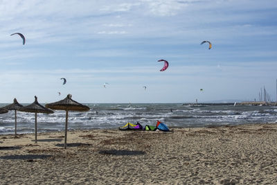 People on beach against sky