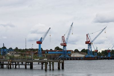 Cranes against sky