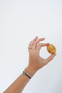 Midsection of woman holding ice cream against white background