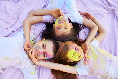 High angle view of mother and daughter lying on bed at home