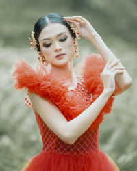 Portrait of young woman standing outdoors