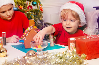 Portrait of girl playing with christmas decoration