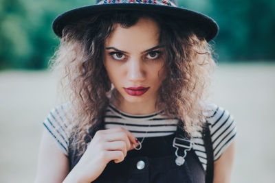 Portrait of beautiful young woman standing outdoors