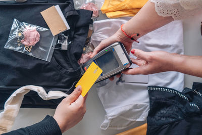 Midsection of woman holding paper currency