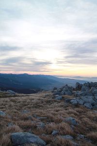 Scenic view of landscape against cloudy sky