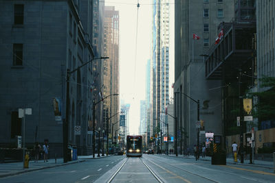 Cable car amidst buildings on street in city