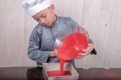 Boy preparing food on table at home