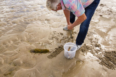 High angle view of woman standing on beach