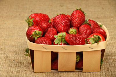 Close-up of strawberries in box on carpet