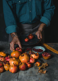 Midsection of man holding fruits