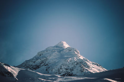 Scenic view of snowcapped mountains against clear sky