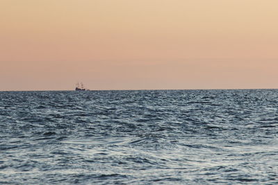 Scenic view of sea against clear sky during sunset