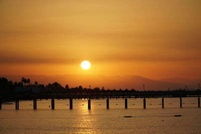 Scenic view of sea against orange sky