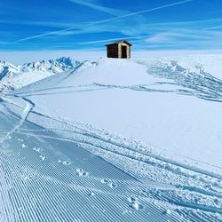 Scenic view of snow covered mountain against blue sky