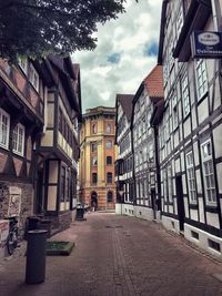 Street amidst buildings in city against sky