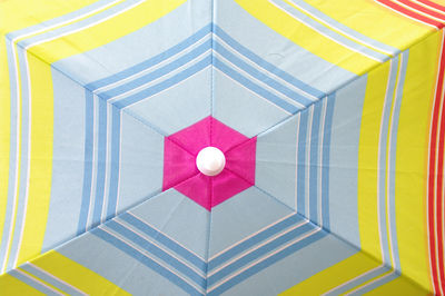 Low angle full frame view of multi summer bright colored umbrella