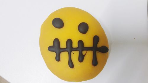 Close-up of smiley face over white background
