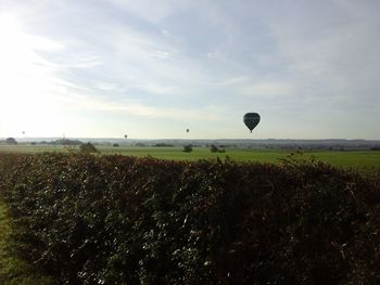 Hot air balloon on field against sky