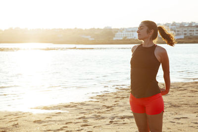 Young woman exercising at beach