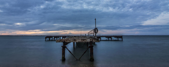 Lifeguard hut on sea against sky