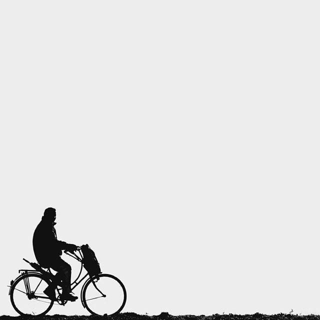 bicycle, land vehicle, transportation, mode of transport, copy space, clear sky, riding, stationary, parked, cycling, parking, side view, full length, silhouette, day, motorcycle, outdoors, road, travel, street