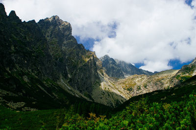 Scenic view of mountains against cloudy sky