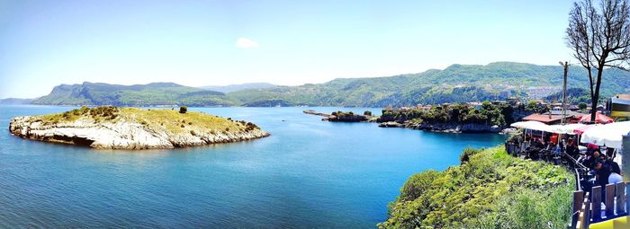 Panoramic view of bay against sky