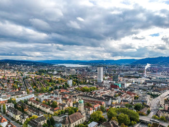 High angle view of cityscape against cloudy sky