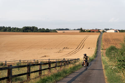 People walking on field against sky