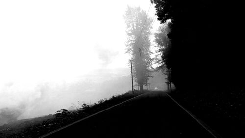 Road passing through foggy weather