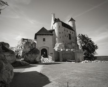 Historic building by trees against sky