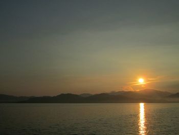 Scenic view of sea and mountains during sunset