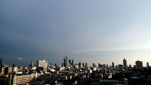 Aerial view of modern buildings in city against sky