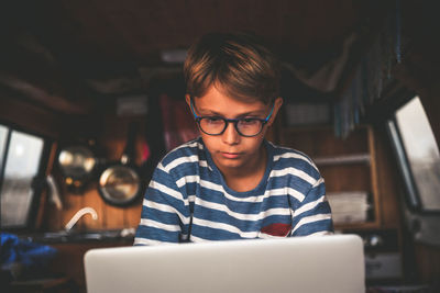 Boy using laptop in motor home