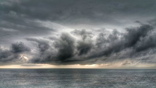 Scenic view of sea against cloudy sky