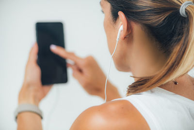 Woman with headphones self-testing hearing